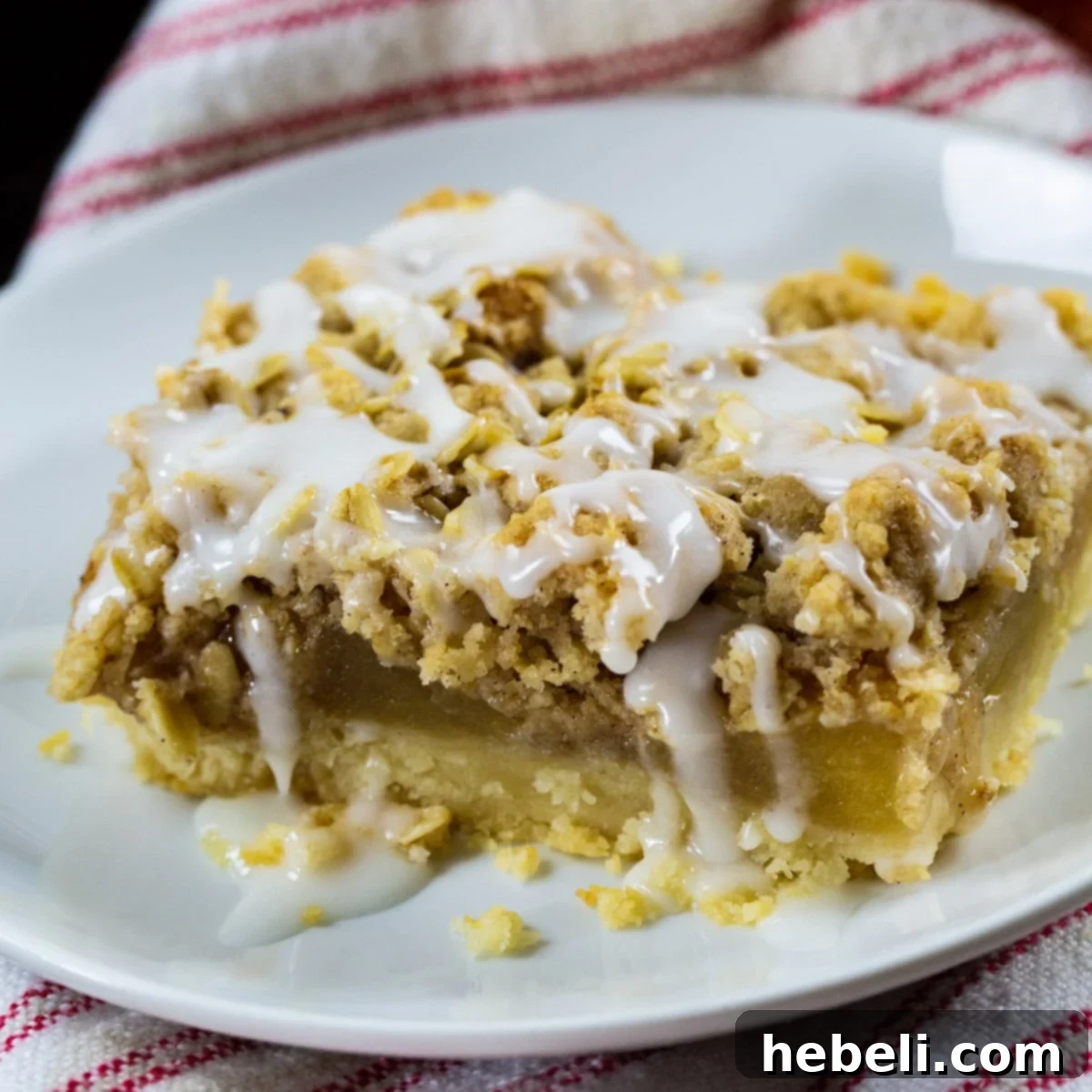 A delicious Oatmeal Crumb Apple Bar on a plate, ready to be enjoyed.