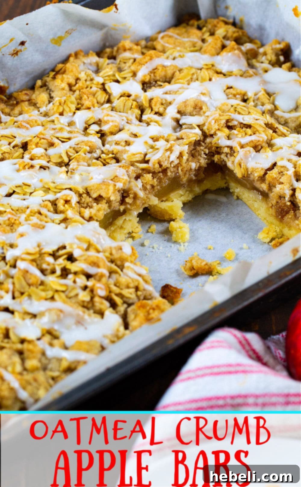 Oatmeal Crumb Apple Bars arranged in a baking pan, with one bar thoughtfully removed to showcase its layered interior.