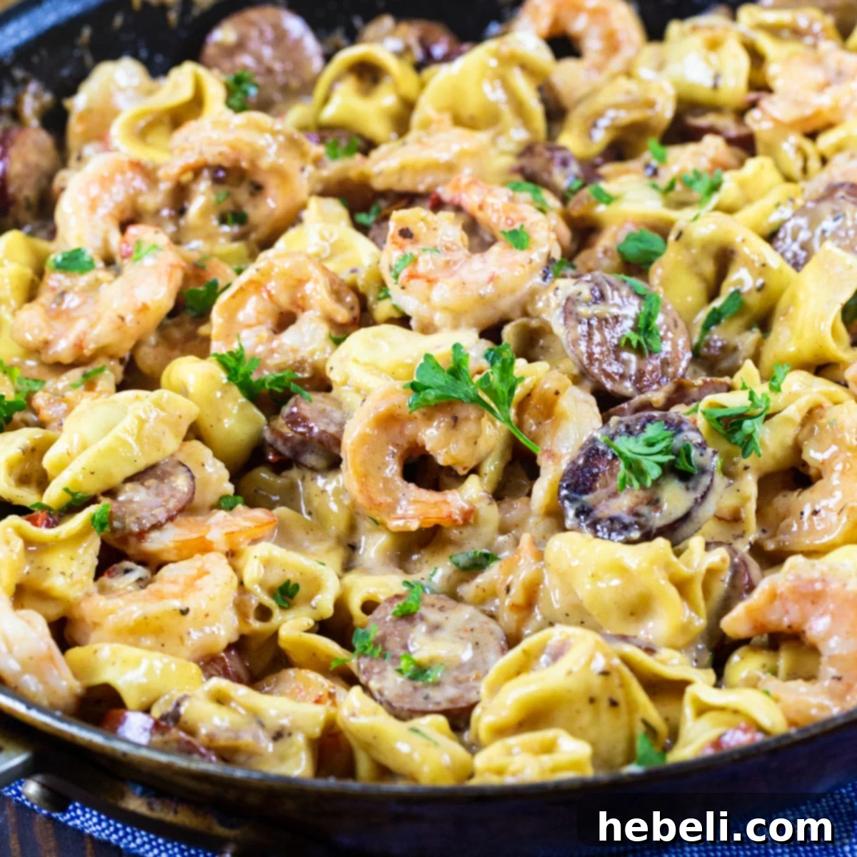 Velvety Shrimp Tortellini 2 Creamy Tortellini with Shrimp and Smoked Sausage, generously portioned in a large skillet, ready to serve.