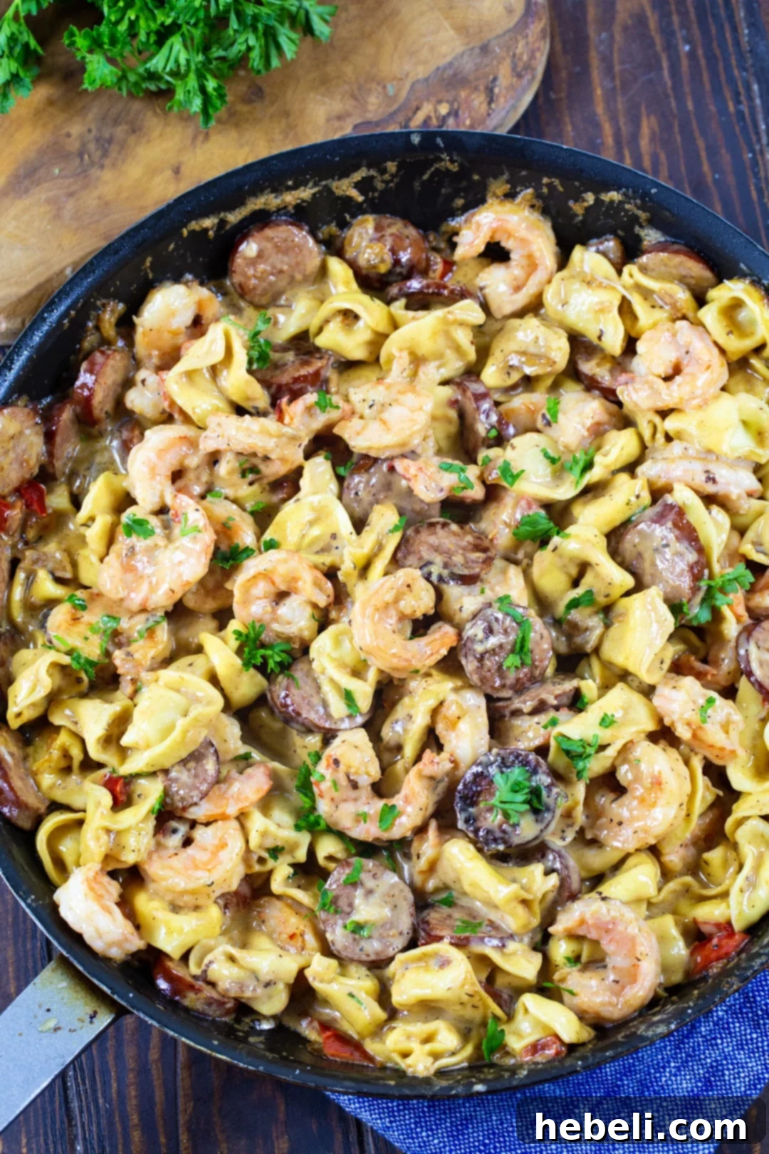 Velvety Shrimp Tortellini 3 Creamy Tortellini with Shrimp and Smoked Sausage in a large skillet, featuring vibrant colors of bell pepper and onion.