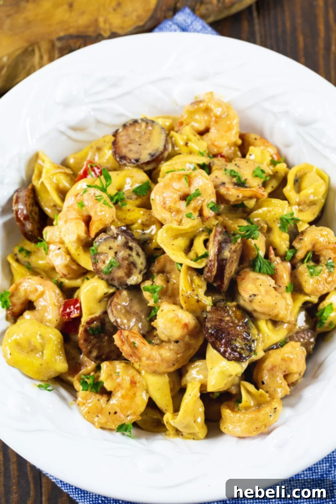 Velvety Shrimp Tortellini 4 Creamy Tortellini with Shrimp and Smoked Sausage dished up in a pasta bowl, garnished with fresh parsley.