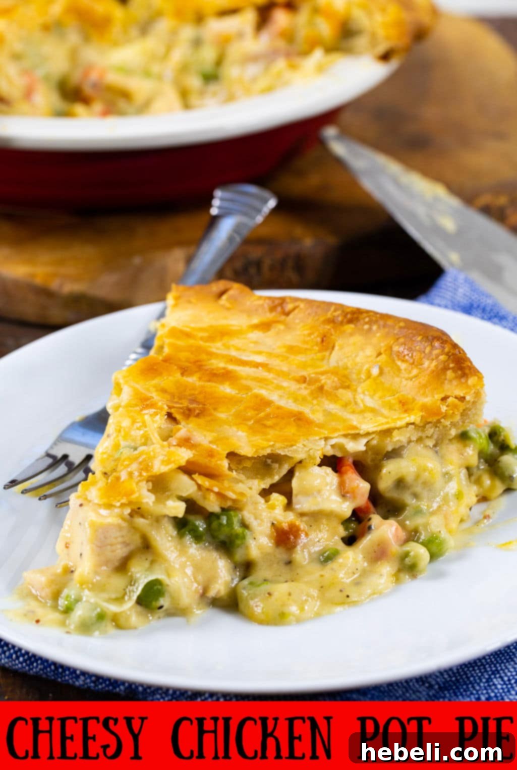 An inviting slice of Cheesy Chicken Pot Pie on a plate, perfectly showing the golden crust and the creamy, savory filling.