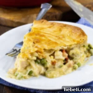 A freshly baked Cheesy Chicken Pot Pie in a pie pan.