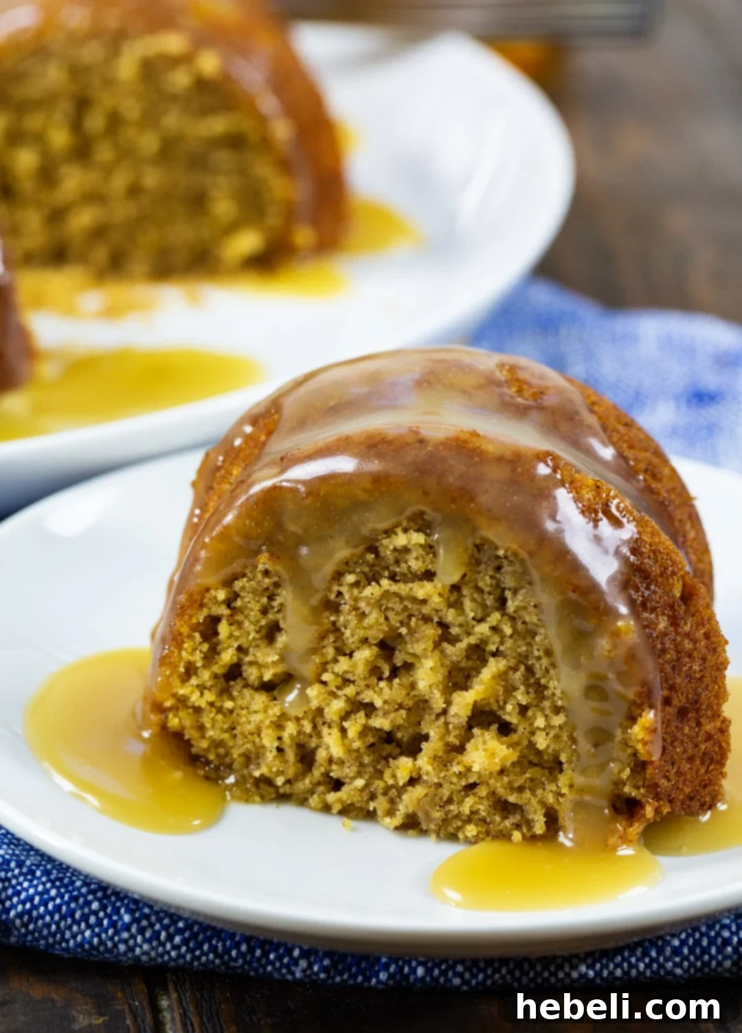 Fireside Butternut Bourbon Cake 3 A close-up shot of a slice of Butternut Squash Cake with Bourbon Glaze, perfectly drizzled and ready to be enjoyed.