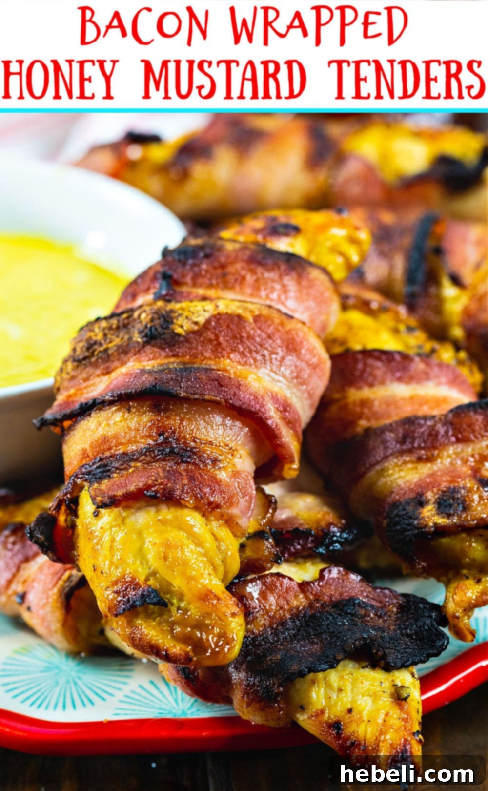 Crispy Bacon-Wrapped Honey Mustard Chicken 4 A close-up of a stack of golden-brown Bacon-Wrapped Honey Mustard Chicken Tenders, highlighting their crispy bacon exterior and glistening marinade.