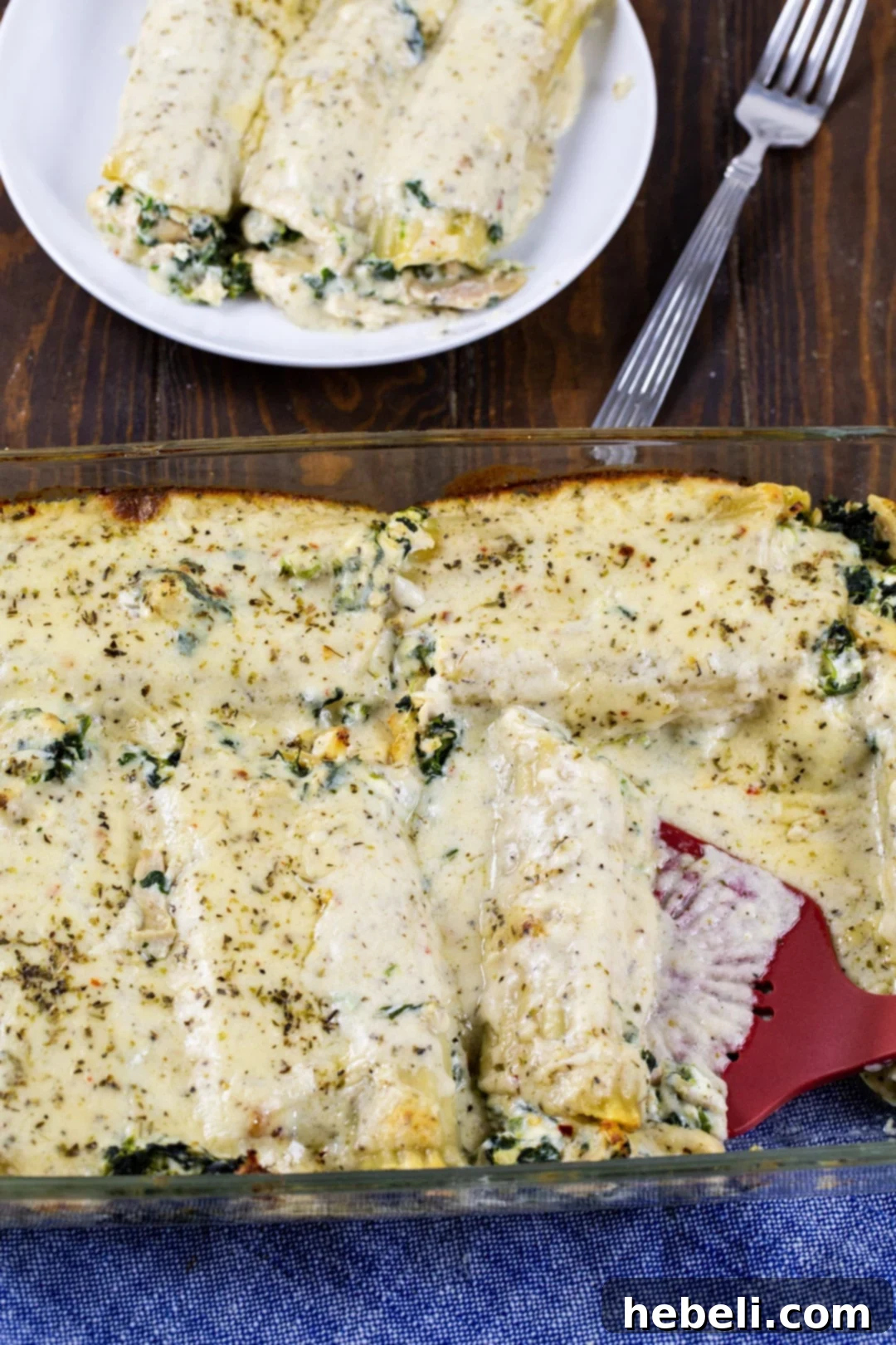 Creamy Chicken Florentine Manicotti 4 Chicken Florentine Manicotti in a baking dish, glistening with creamy parmesan sauce.