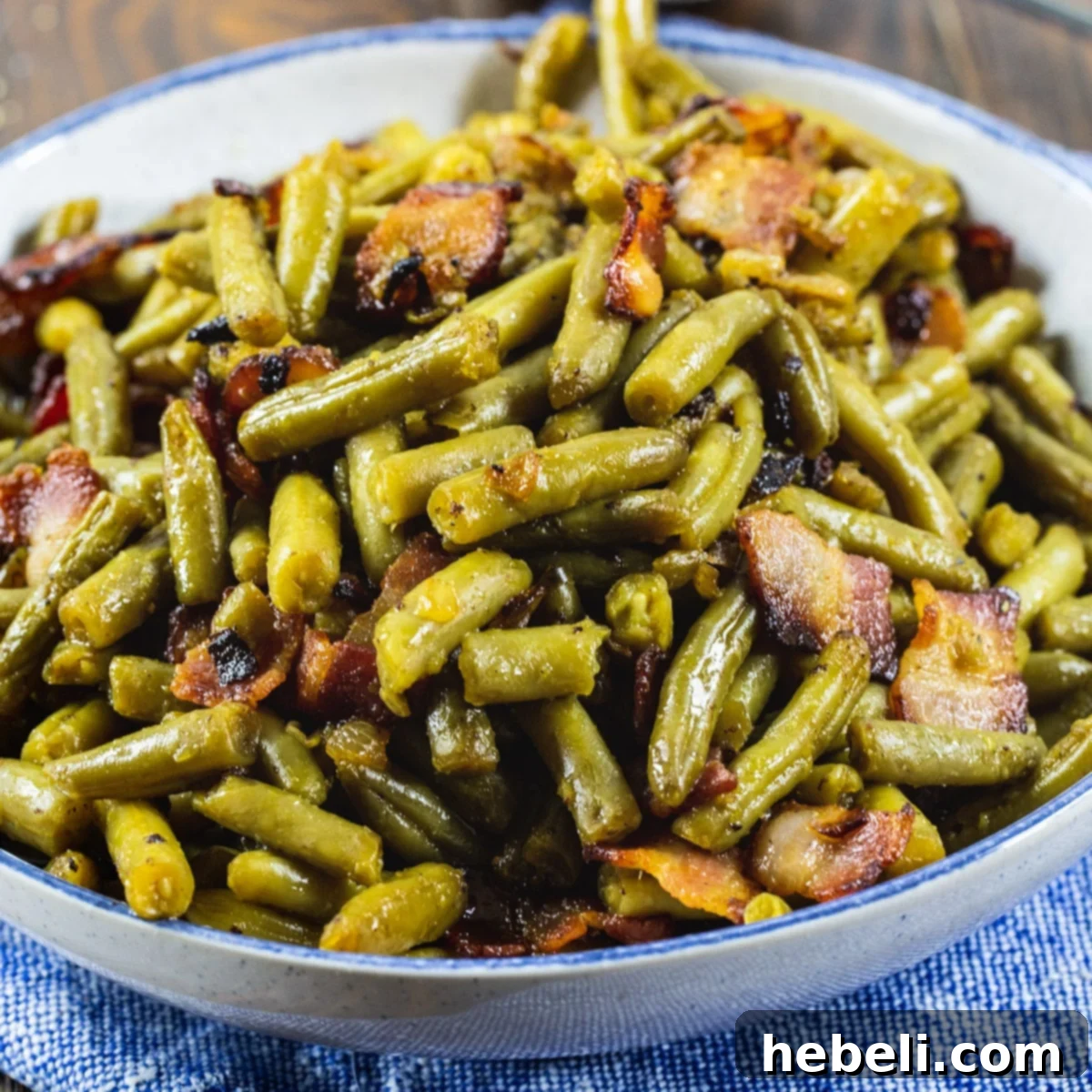 Candied Green Beans in a serving bowl, garnished with crispy bacon.
