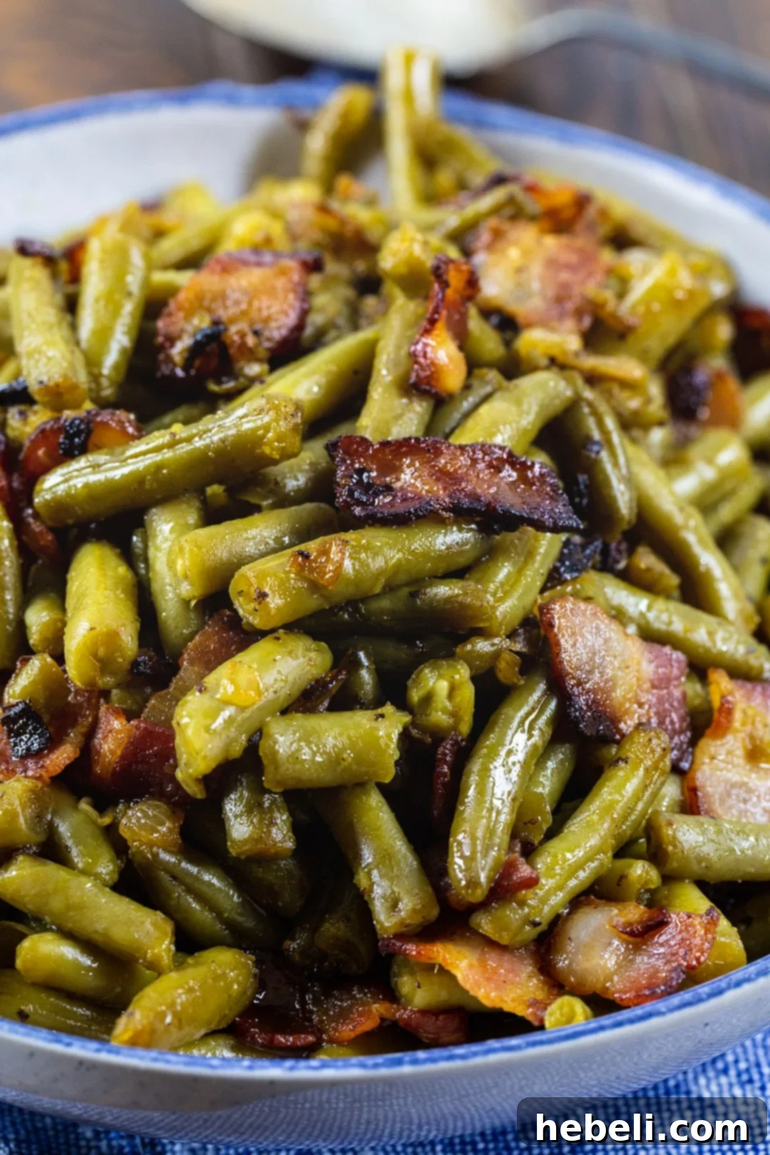 Candied Green Beans with crispy bacon in a white serving dish.