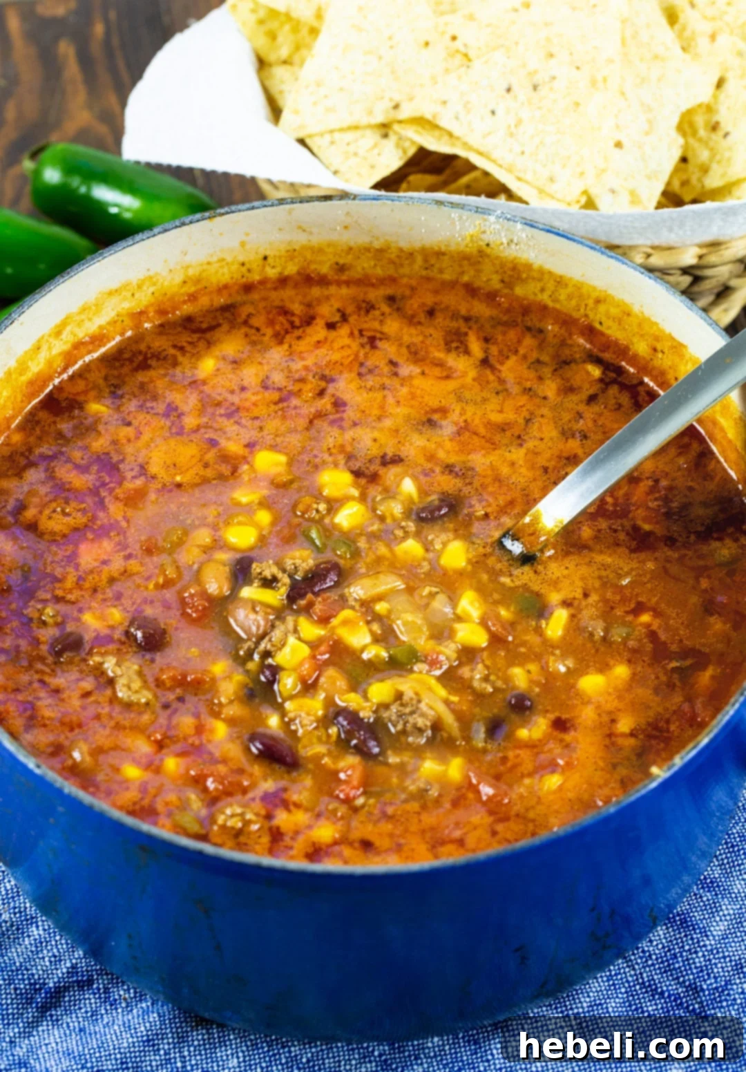 Hearty Taco Soup simmering in a rustic Dutch oven on a stove, ready to be served.