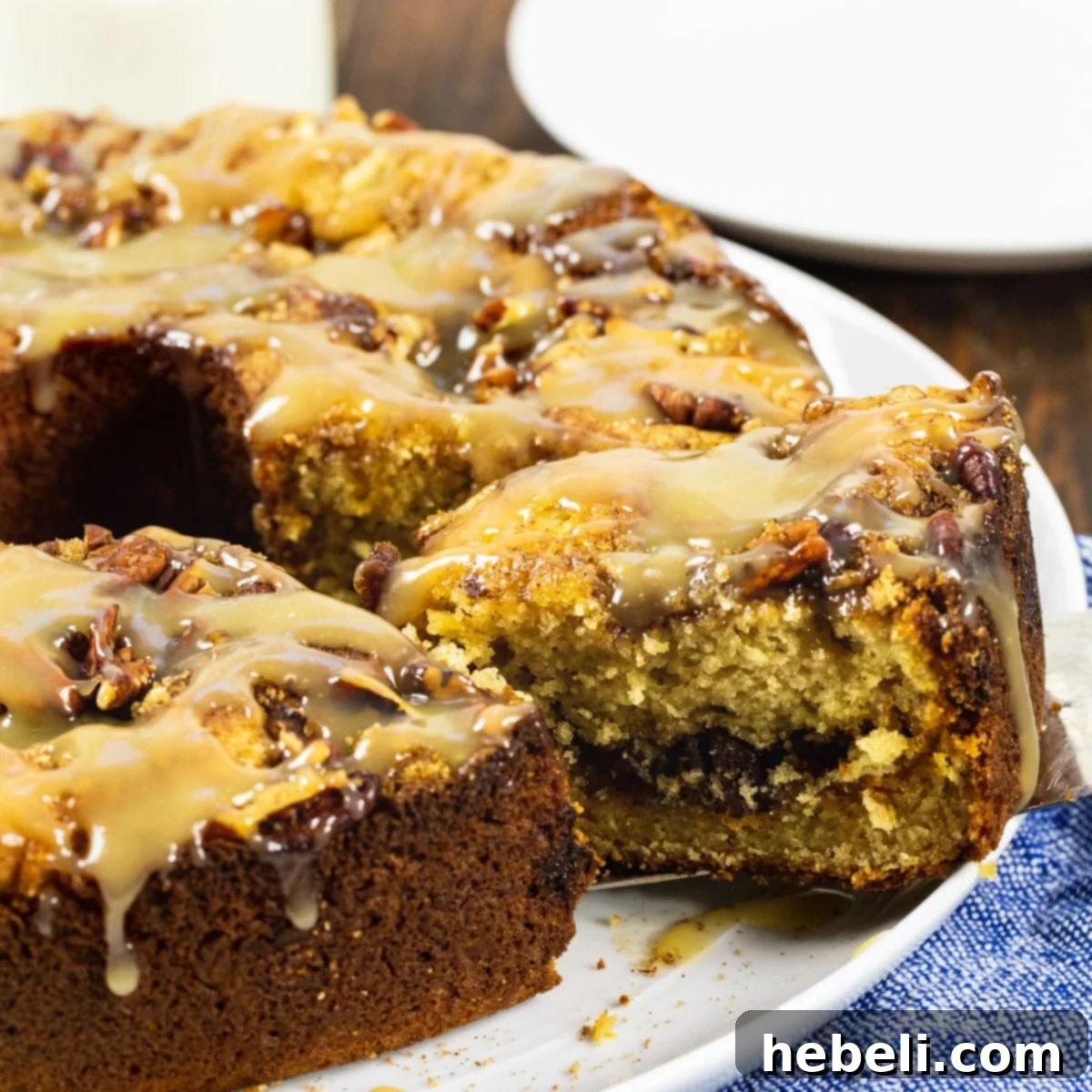Butterscotch Streusel Coffee Cake 2 A tantalizing slice of homemade Butterscotch Coffee Cake being lifted, revealing its moist crumb, butterscotch chips, and pecan streusel.