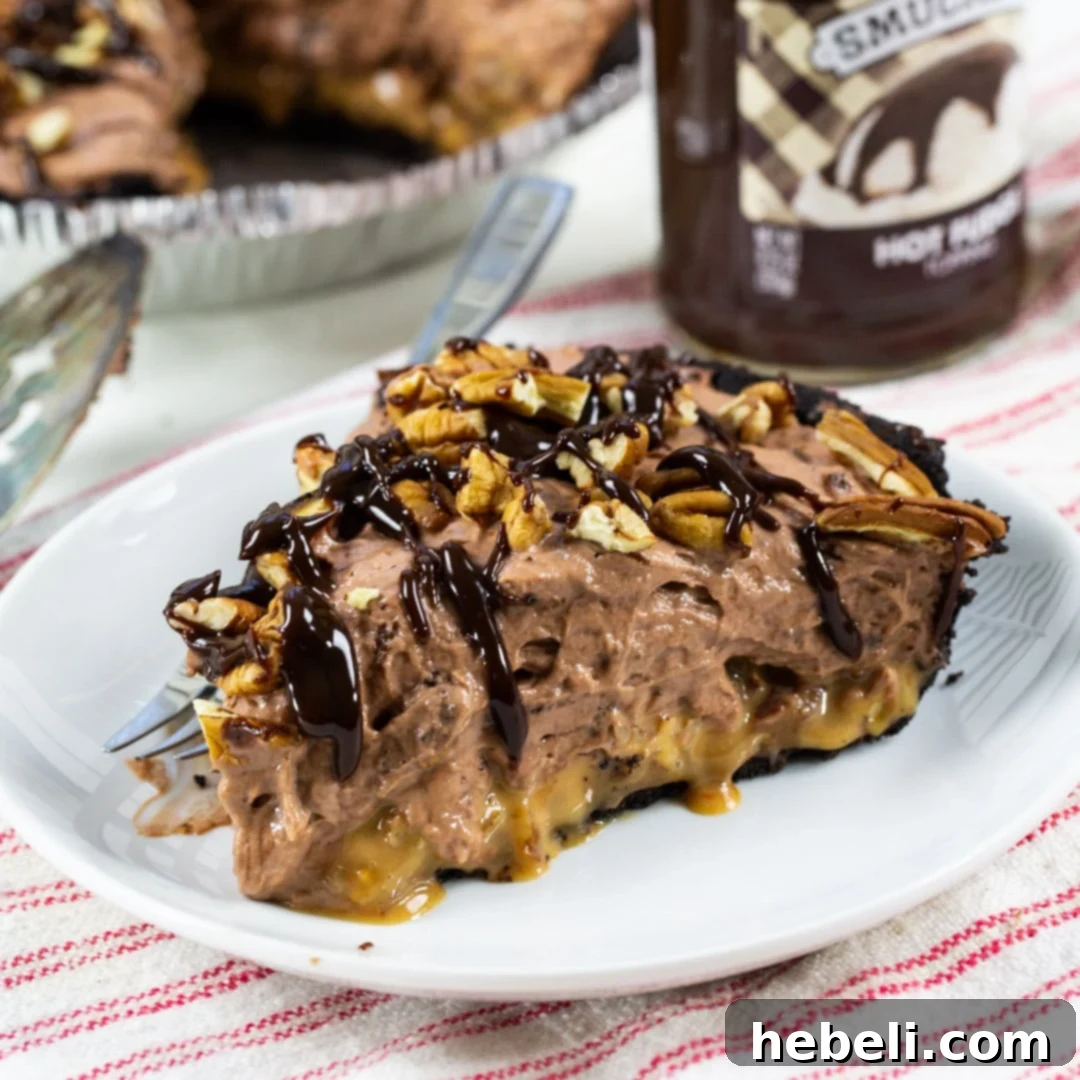 Decadent Chocolate Caramel Dream 2 A perfectly sliced piece of Chocolate Caramel Pie on a white plate, showcasing its distinct layers.