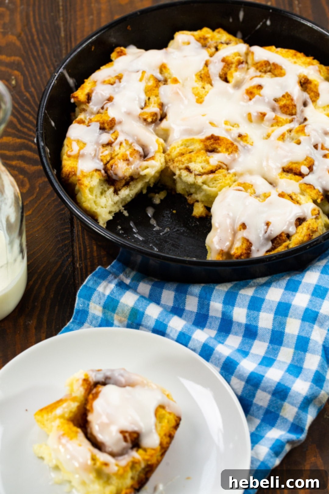 Fluffy Buttermilk Biscuit Cinnamon Rolls 3 Freshly baked Buttermilk Biscuit Cinnamon Rolls arranged in a rustic cast iron pan, ready for glazing.