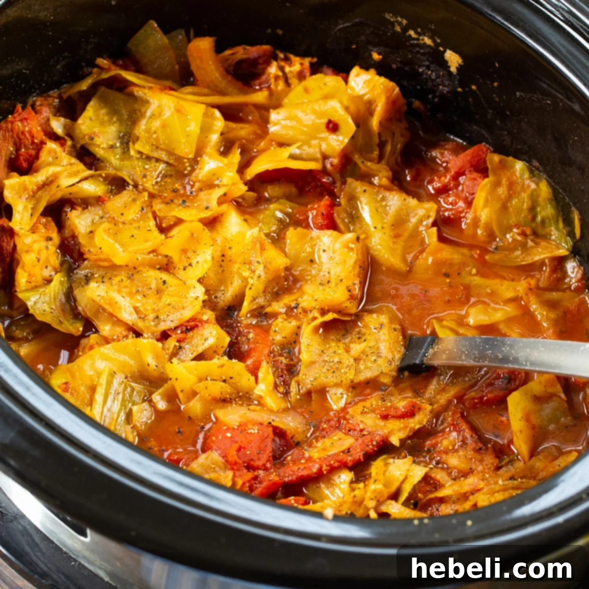 Cabbage and Stewed Tomatoes simmering in a slow cooker.