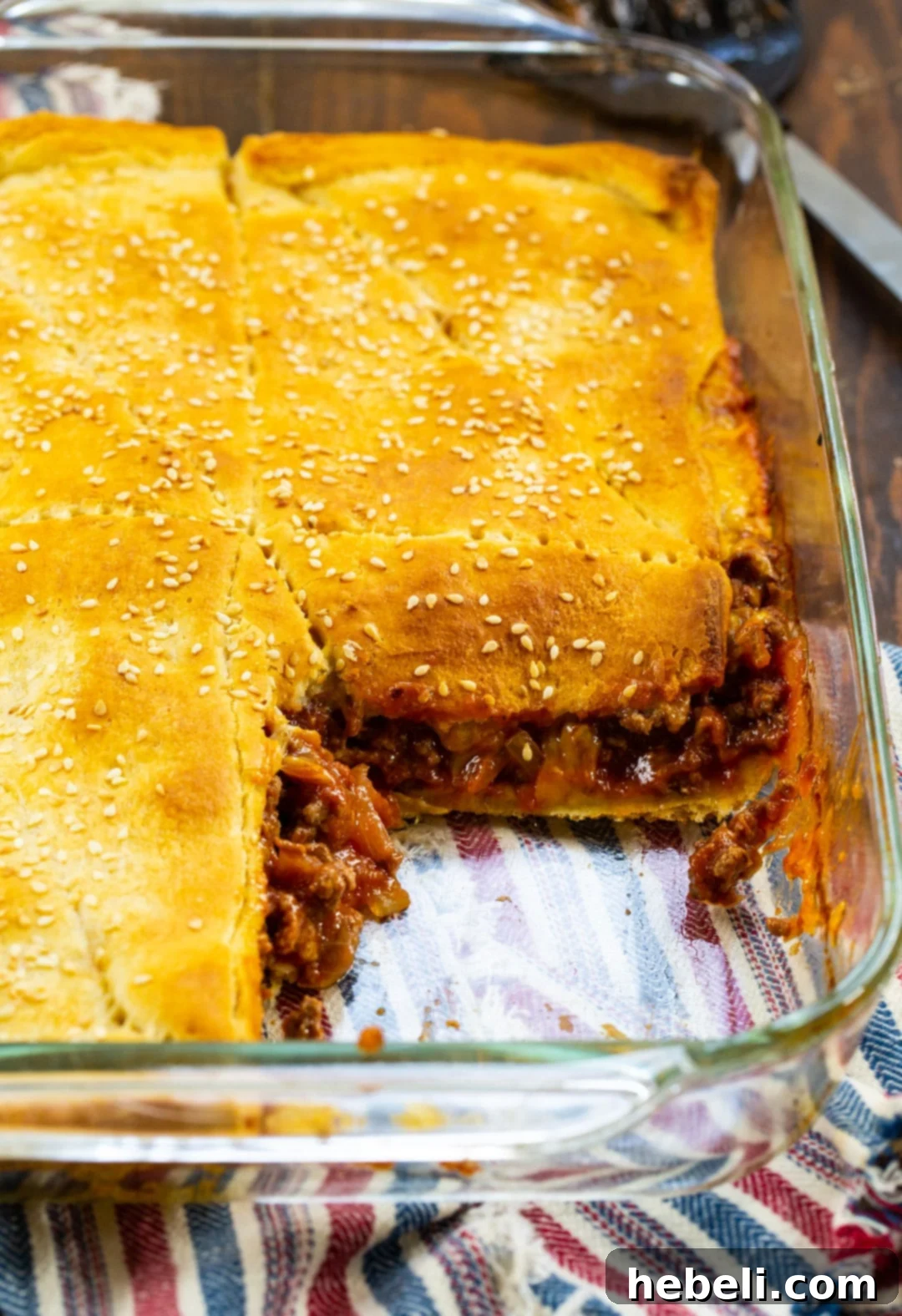 Sloppy Joe Crescent Squares baking in a 9x13-inch dish, golden brown and bubbly.
