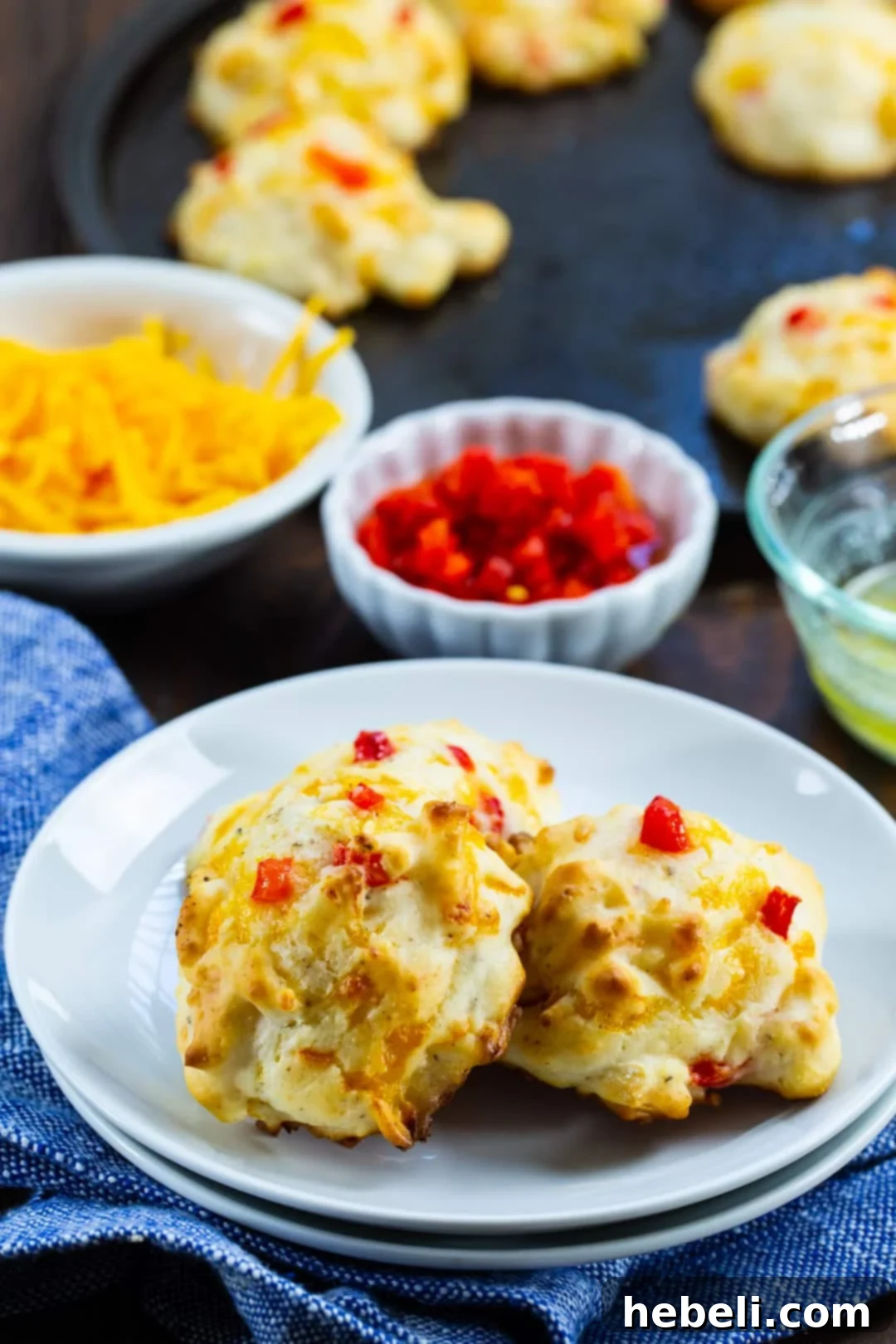 Cheesy Pimento Drop Clouds 4 Pimento Cheese Drop Biscuits on a plate.