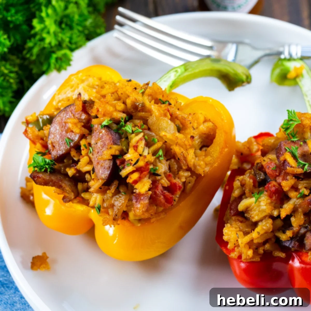 Cajun Jambalaya Stuffed Peppers 2 Two vibrant Jambalaya Stuffed Bell Peppers on a plate, showcasing the rich filling and colorful exterior.