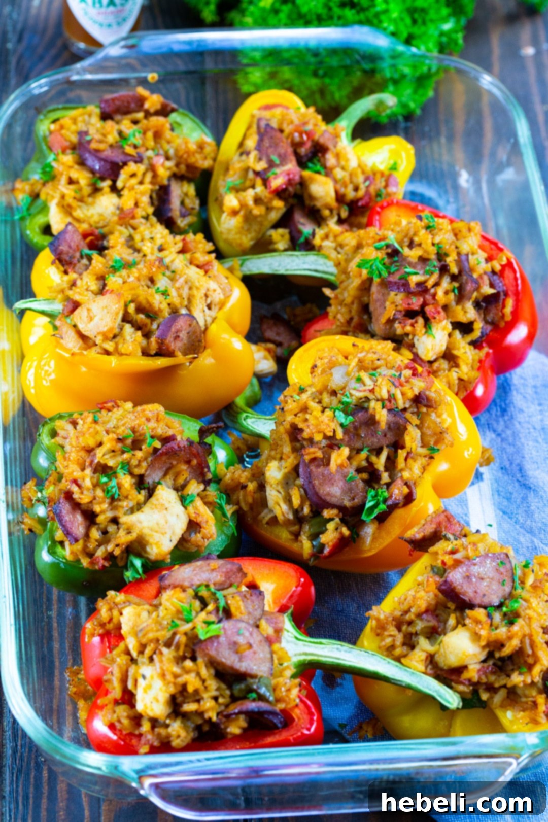 Cajun Jambalaya Stuffed Peppers 3 Jambalaya Stuffed Peppers arranged in a baking dish, ready for the oven.