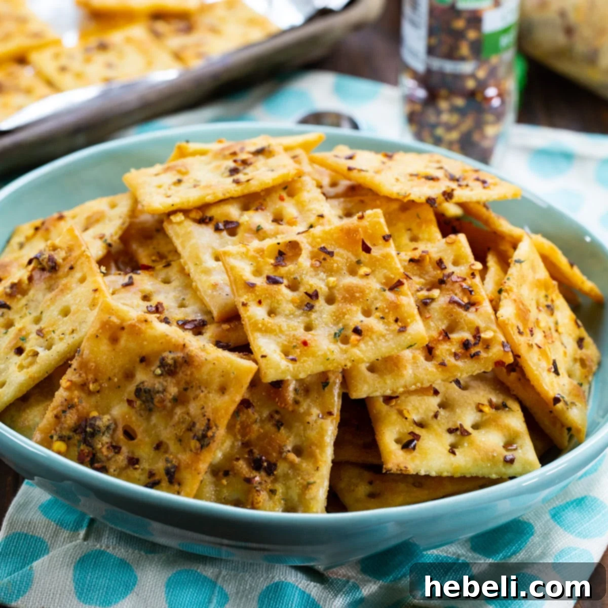 A vibrant blue bowl filled with perfectly seasoned Alabama Fire Crackers, ready to be enjoyed.