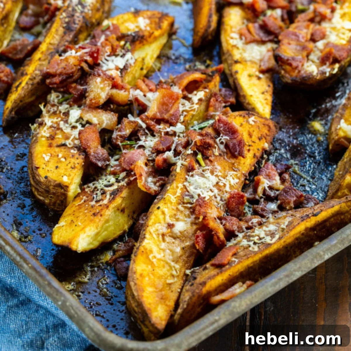 Loaded Bacon Parmesan Steak Fries 2 Bacon Parmesan Steak Fries on baking sheet, freshly baked.