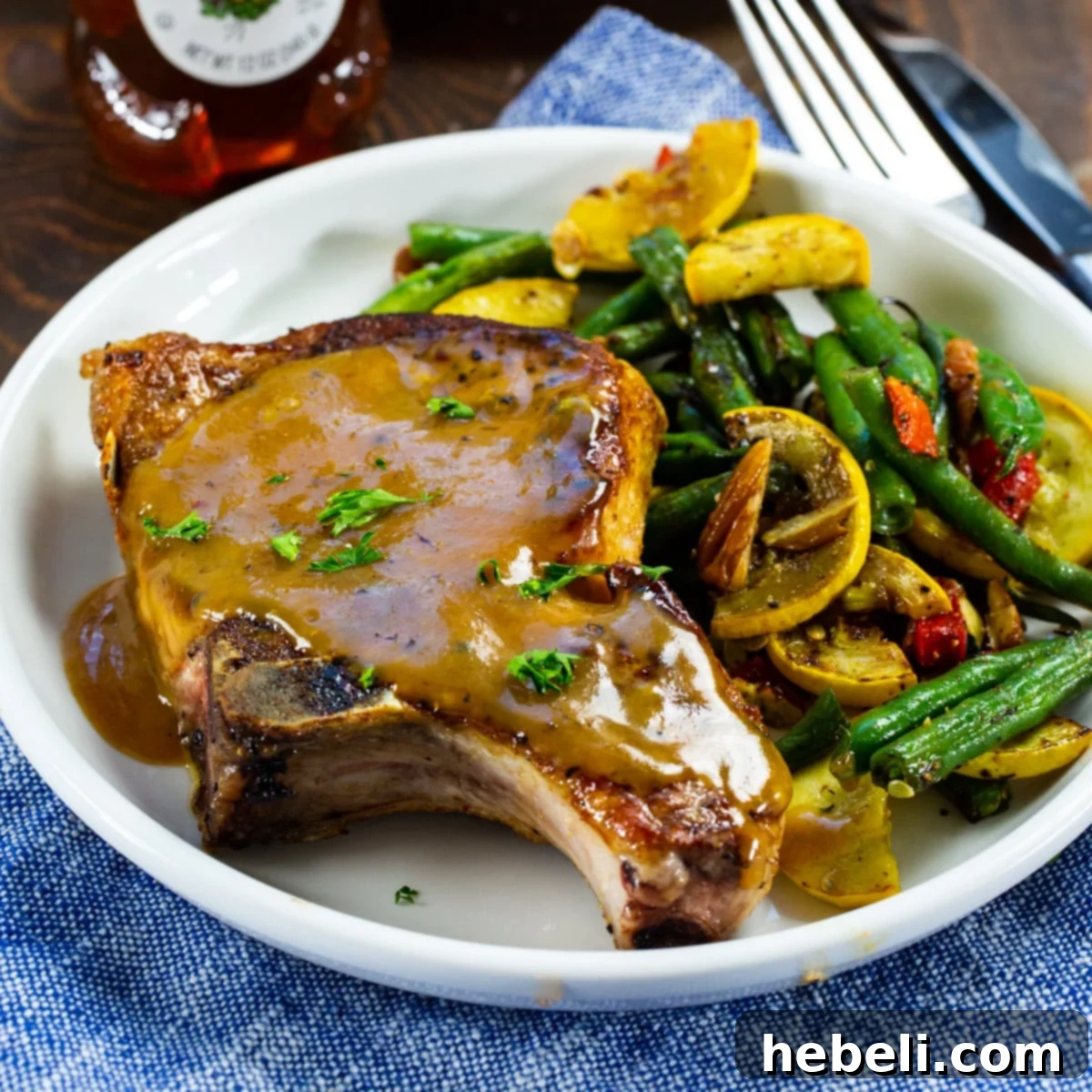 Glazed Honey Mustard Pork Chops 2 Honey Mustard Pork Chops served with vibrant green bean and squash saute, showcasing a perfectly seared chop.