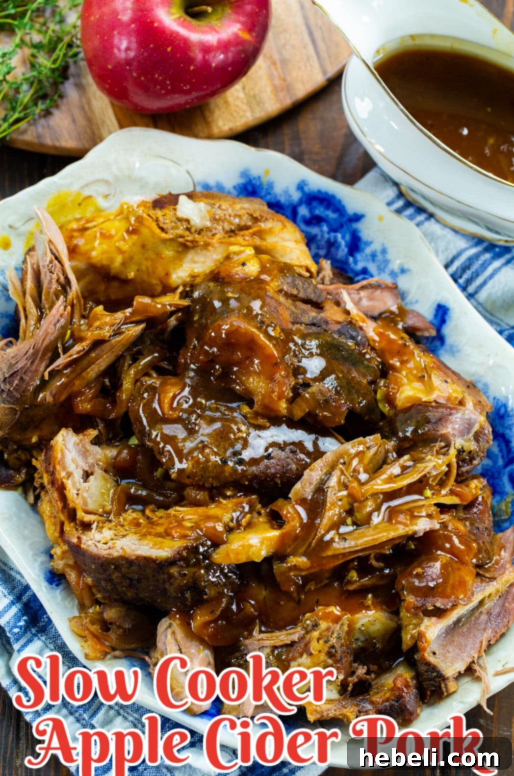 Apple Cider Pork Perfection 4 Slow Cooker Pork on a serving plate, drizzled with gravy and ready to serve.