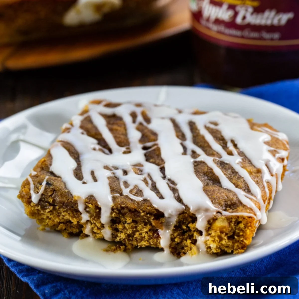 A delightful Apple Butter Bar, beautifully topped with a sweet glaze and ready to be enjoyed on a white plate.