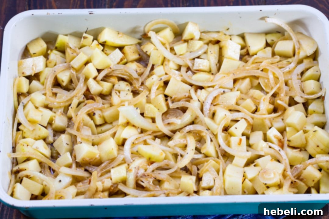 Potatoes and onions in baking dish.