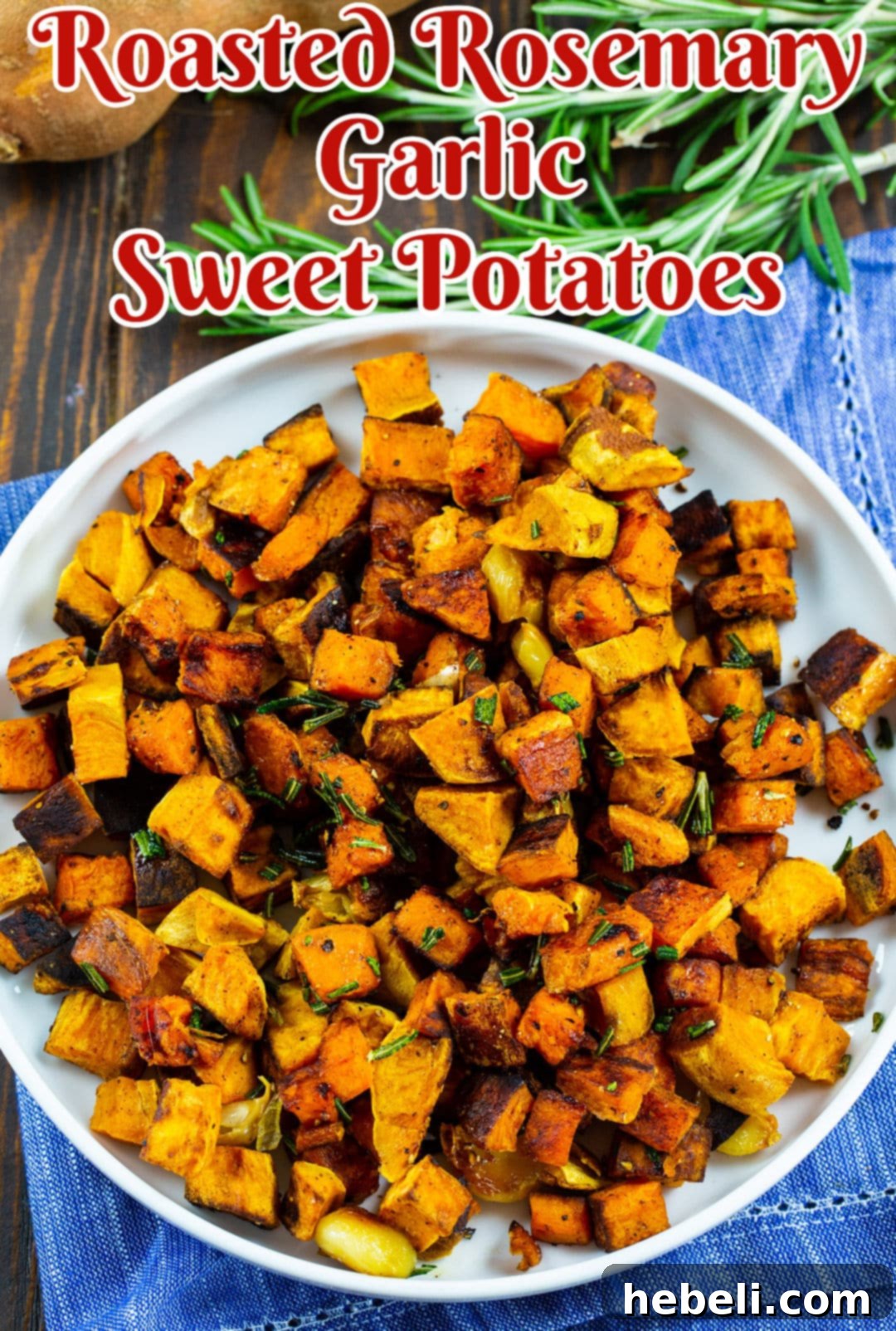 Aromatic Rosemary Garlic Roasted Sweet Potatoes 4 Serving plate filled with golden, crispy roasted rosemary garlic sweet potatoes, garnished with fresh rosemary.