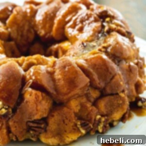 Monkey Bread on a plate, showcasing its gooey texture and golden glaze, ready for serving.