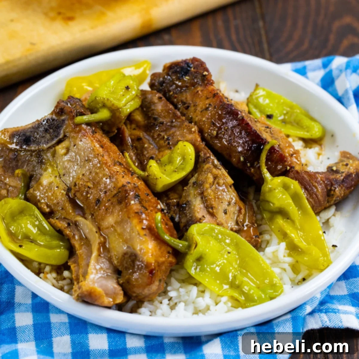 Slow Cooker Mississippi Country Ribs served over fluffy white rice, garnished with fresh herbs.
