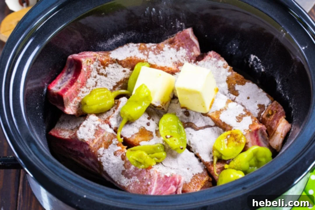 All ingredients for Slow Cooker Mississippi Country Ribs neatly arranged in a slow cooker, ready for cooking.
