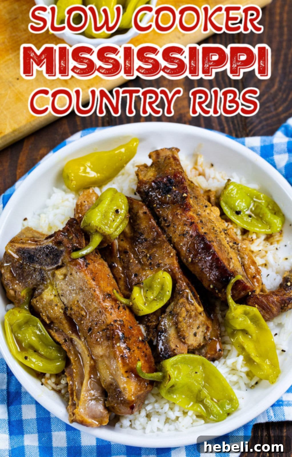 A plate of Slow Cooker Mississippi Country Ribs served over rice, with a side of green beans, ready to eat.