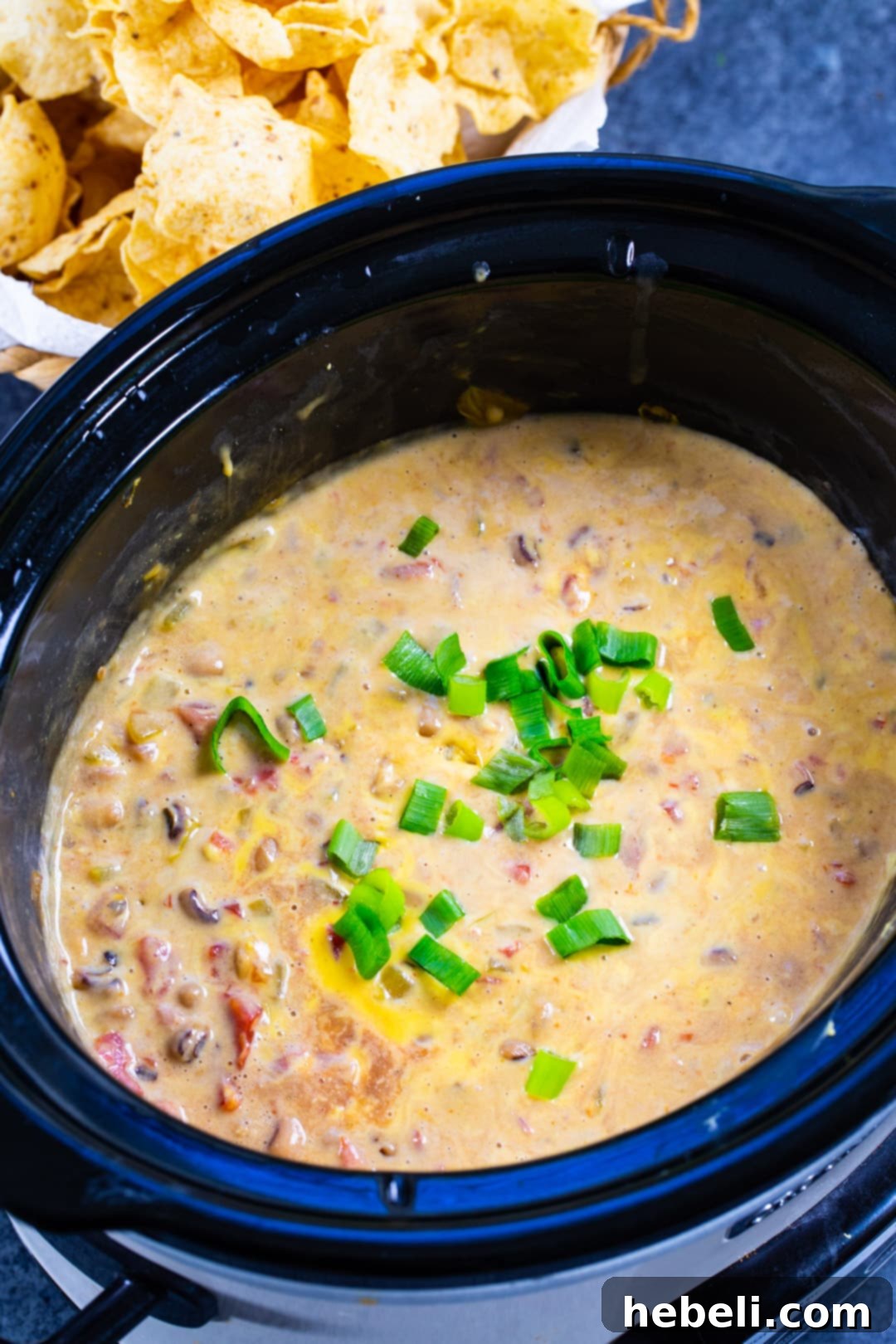 Creamy Slow Cooker Black-Eyed Pea Dip simmering in a slow cooker.