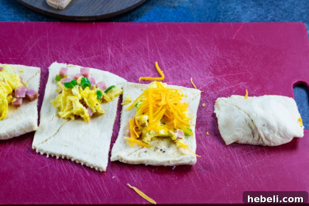 Air Fryer Ham and Egg Bundles 4 Ham and Egg Pockets being assembled, showing the filling and folding process.
