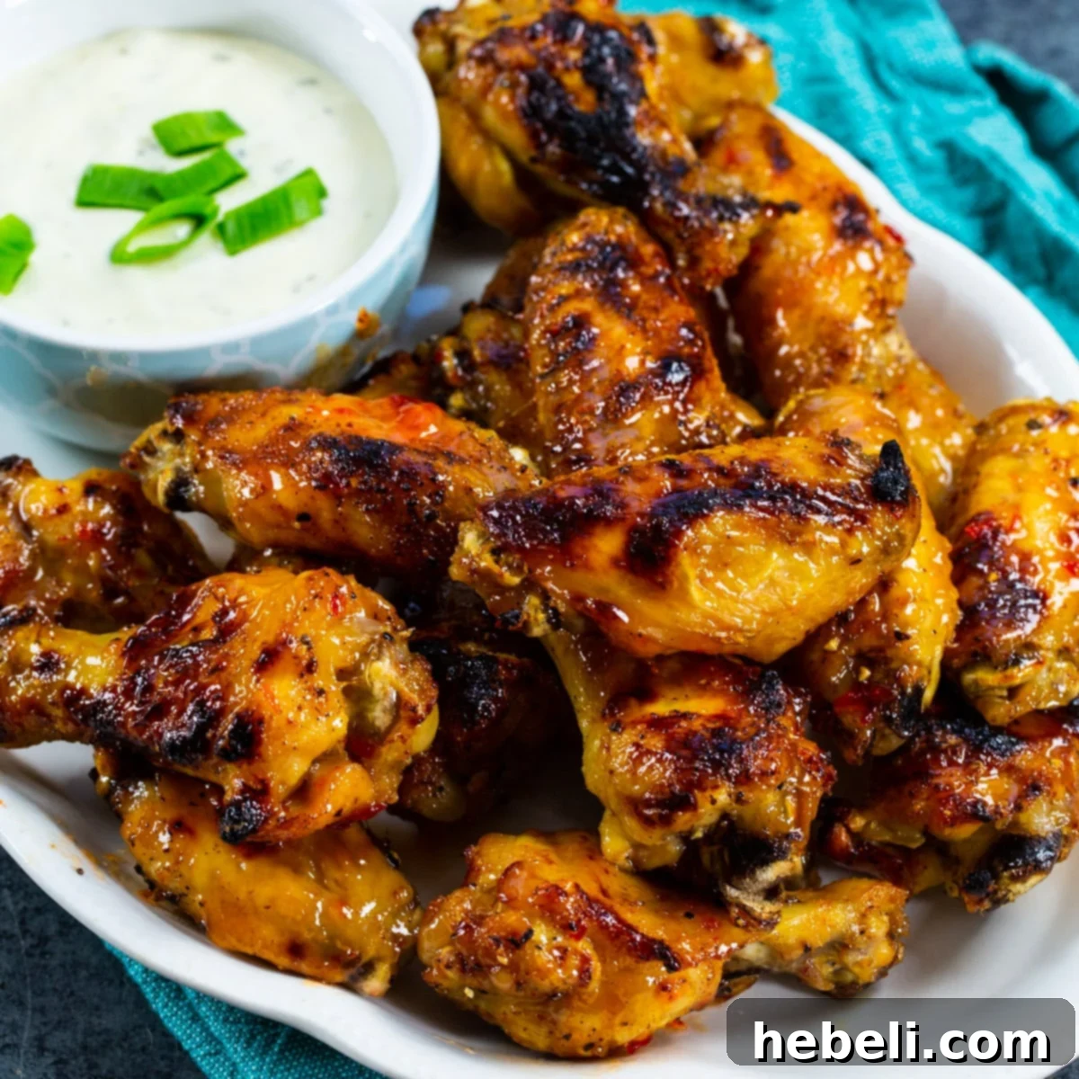 Pepper Jelly Wings on serving plate with bowl of ranch.