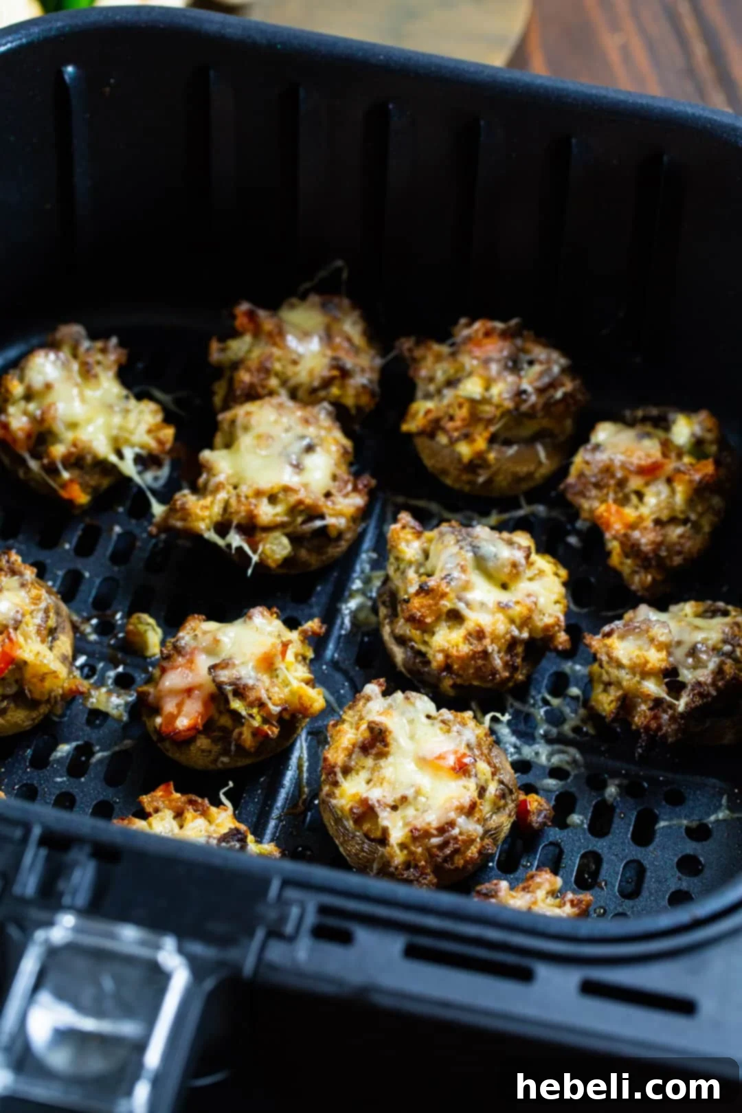 Stuffed Mushrooms arranged neatly in an air fryer basket, ready for cooking.