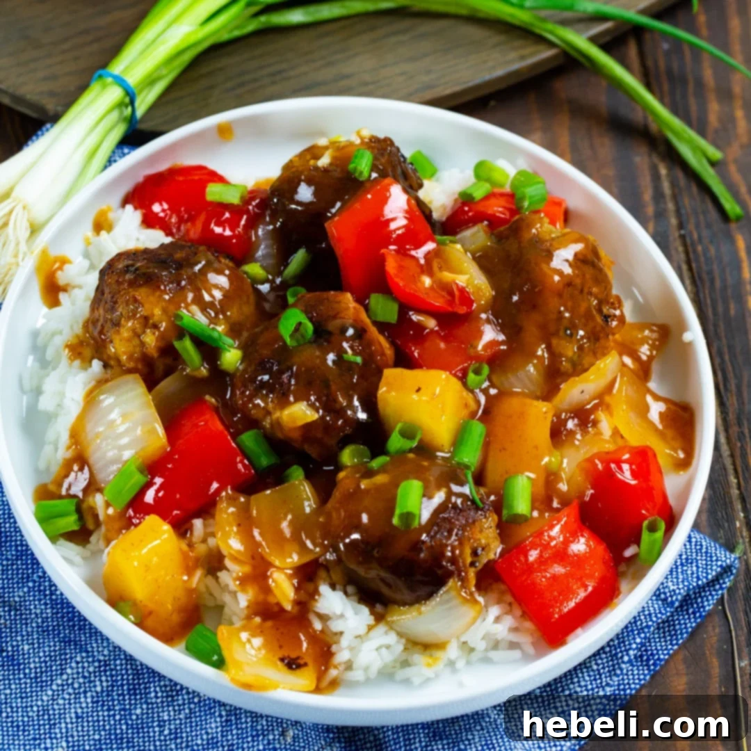 Close-up of Sweet and Sour Meatballs served on a plate with fluffy white rice, ready to enjoy.