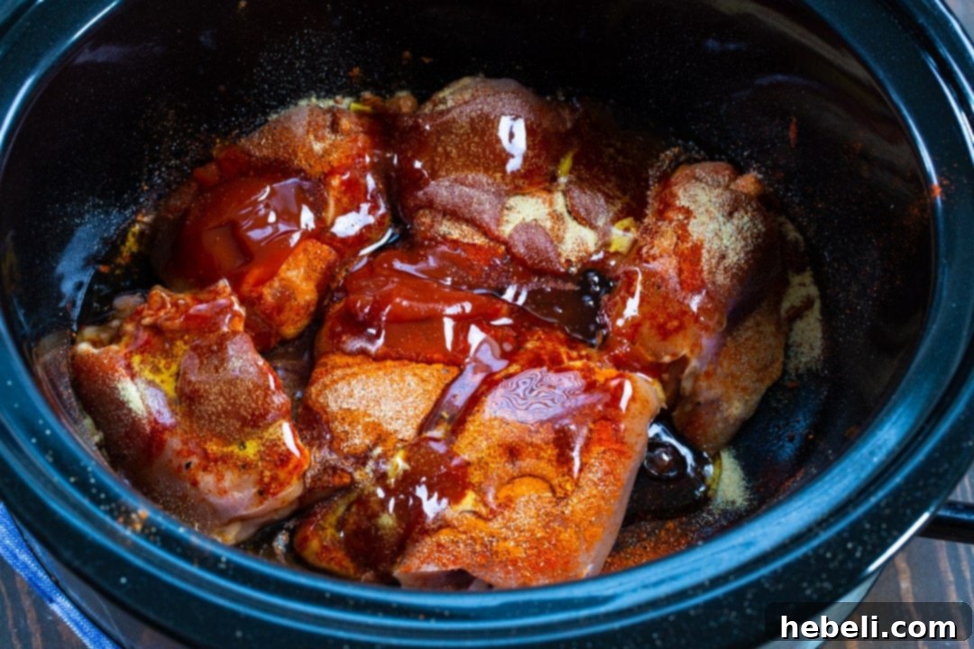 All ingredients assembled in the slow cooker before cooking, ready to be combined.