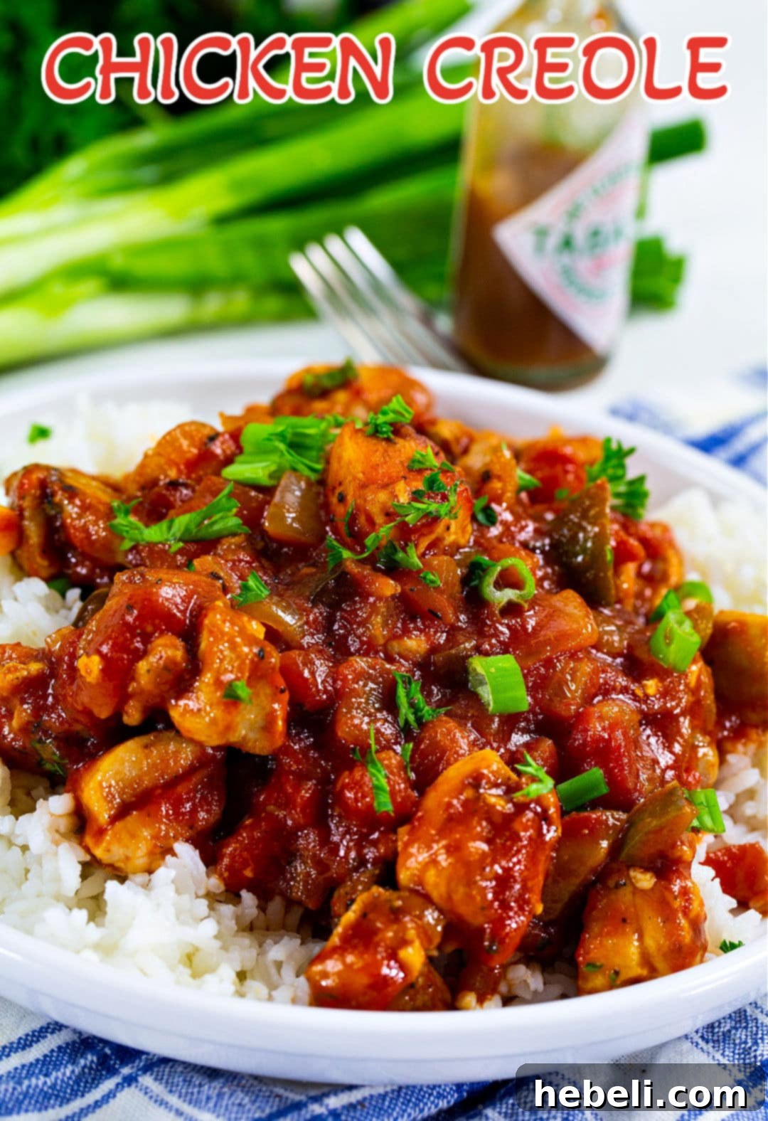 Close-up of Chicken Creole over white rice, showcasing the creamy texture and tender chicken pieces.