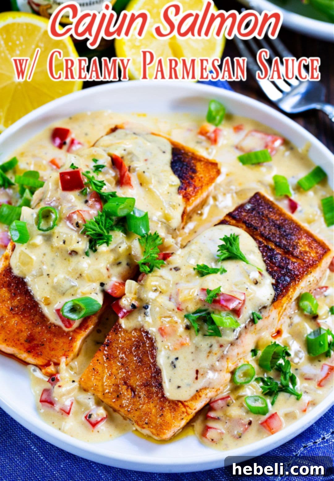 Creamy Parmesan Cajun Salmon 4 Cajun Salmon with Creamy Parmesan Sauce dished up on a plate with greens.