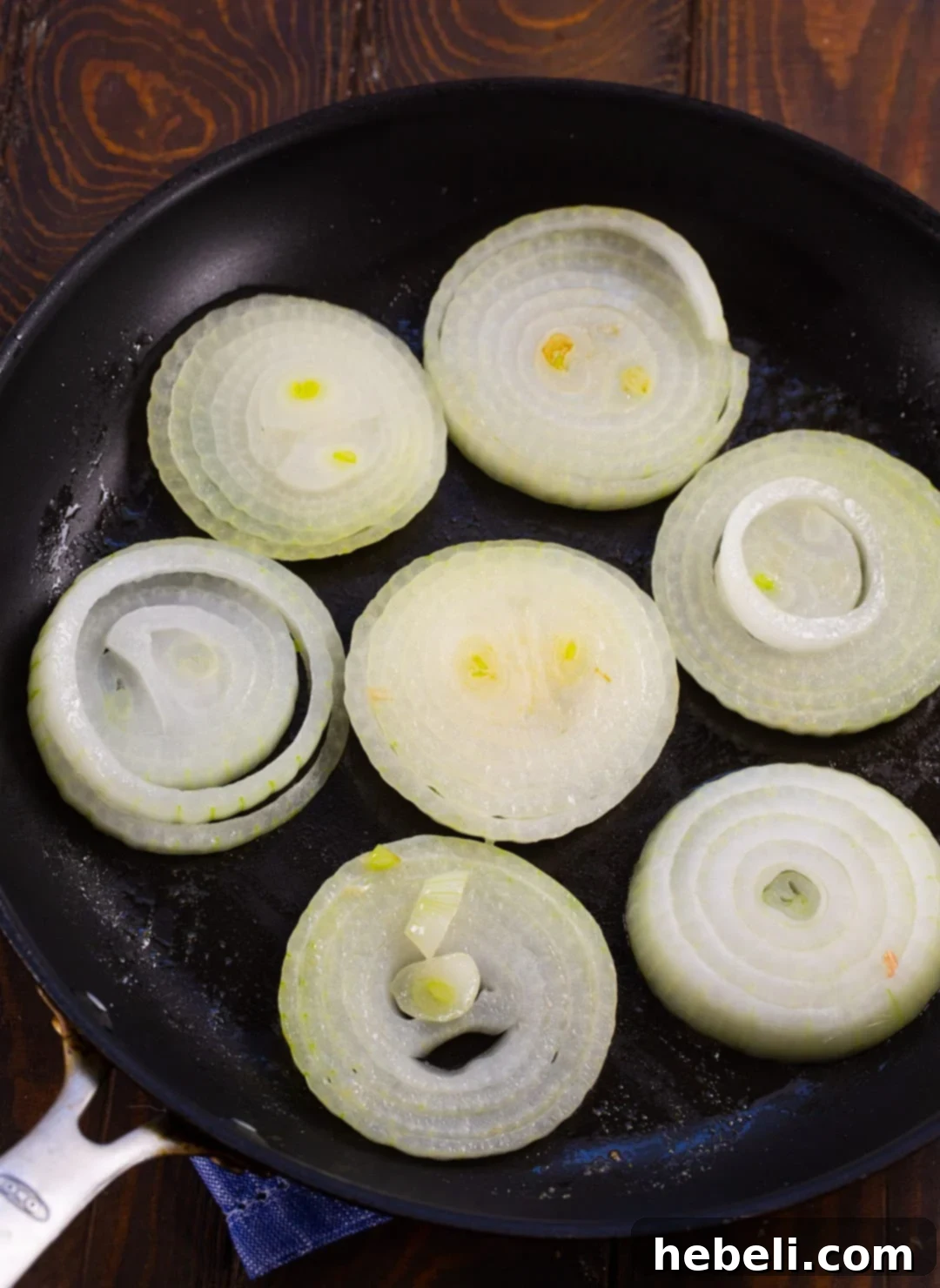 Sweet & Creamy Vidalia Gratin 4 Onions being gently cooked in butter in a nonstick skillet to soften.