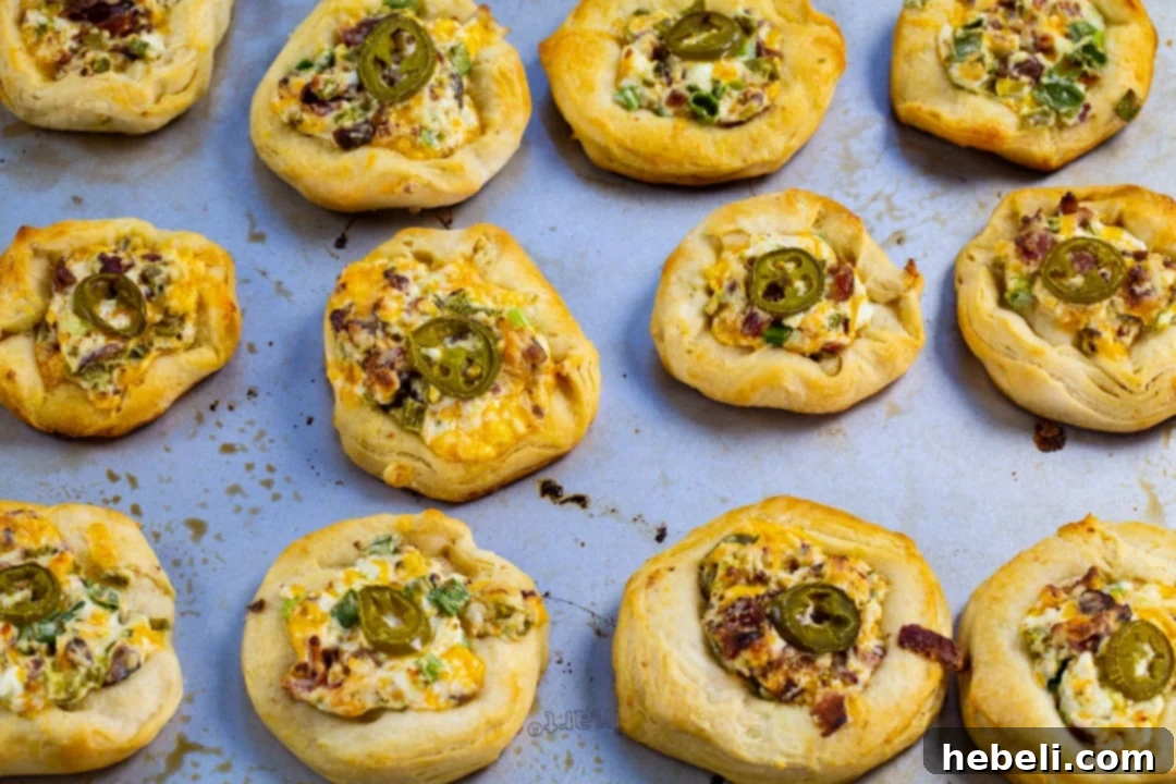 Freshly baked Jalapeno Popper Biscuit Rounds, golden brown and bubbly, just removed from the oven and ready to serve.