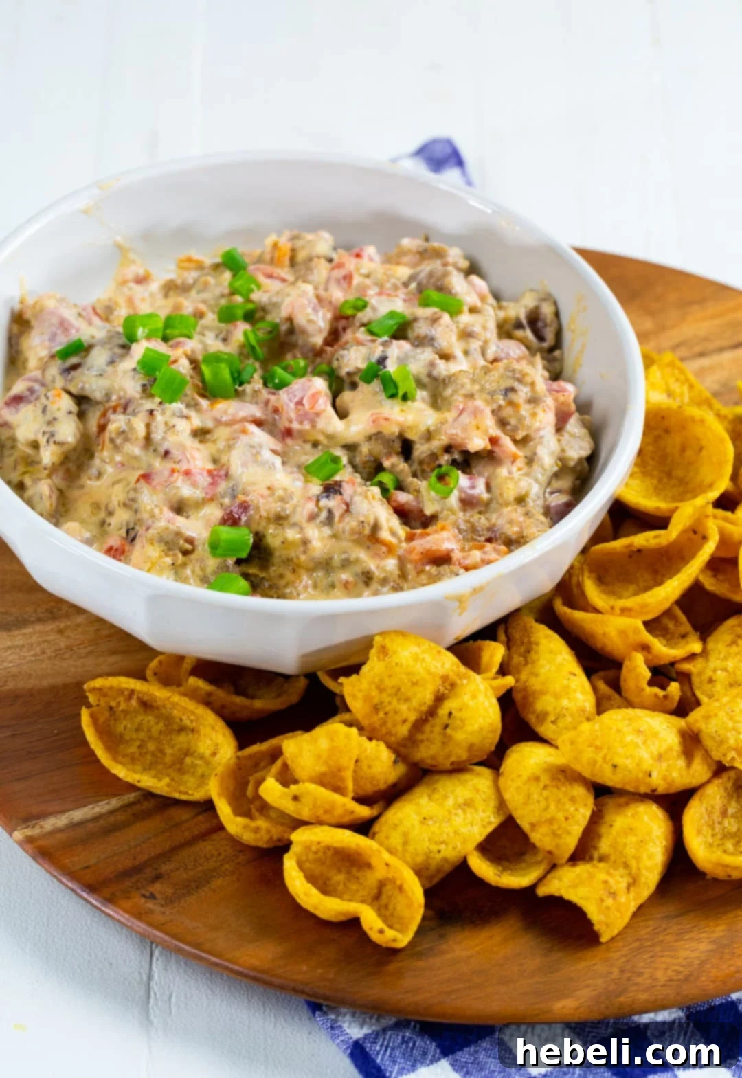 Warm 3-Ingredient Rotel Sausage Dip in a rustic bowl, surrounded by crispy Frito scoops, ready for serving.