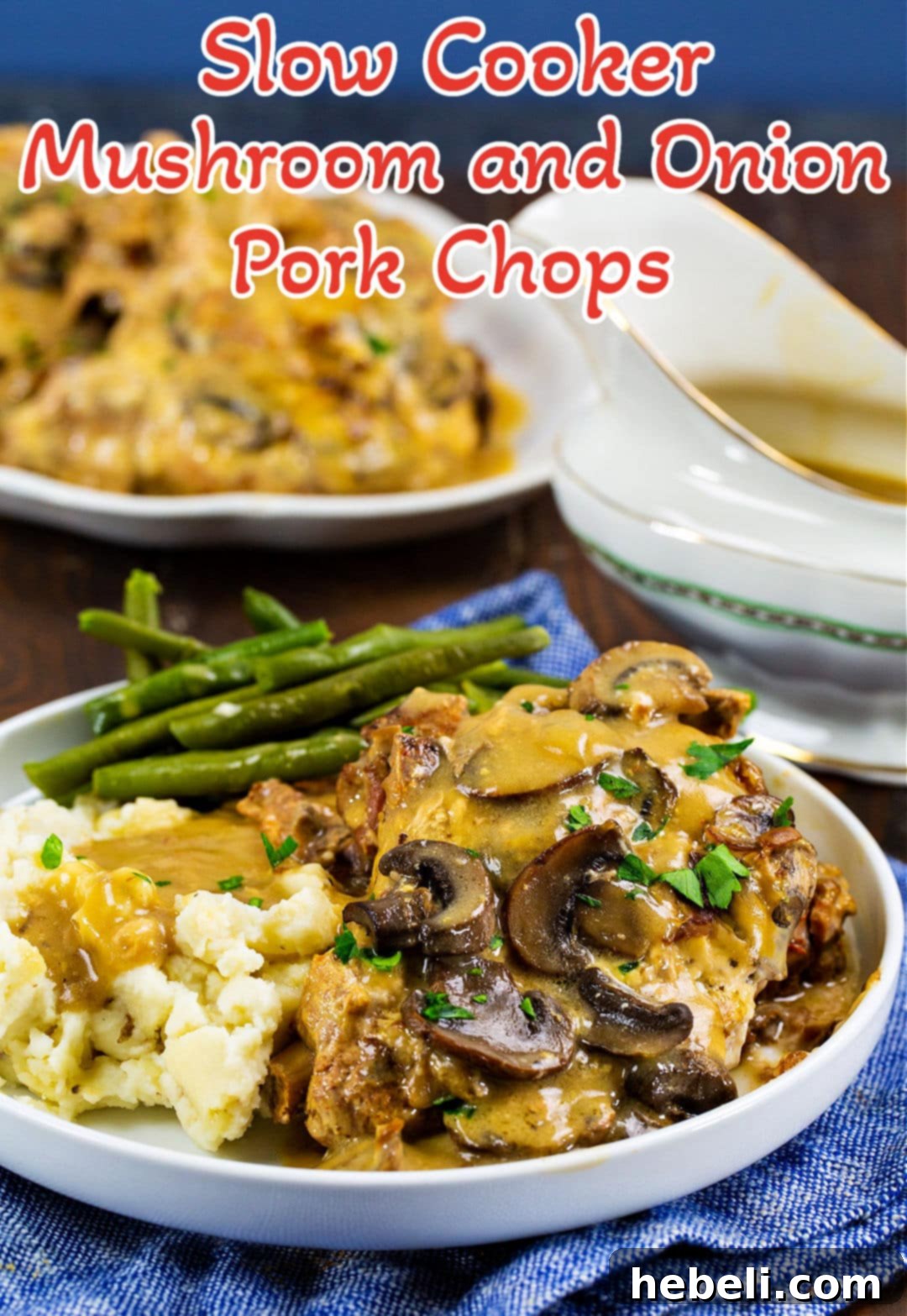 Slow Cooker Mushroom and Onion Pork Chops dished up on plate with mashed potatoes and green beans.