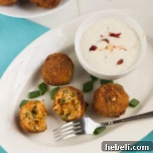A close-up of crispy fried crawfish etouffee balls, golden brown and perfectly cooked, a classic southern appetizer.