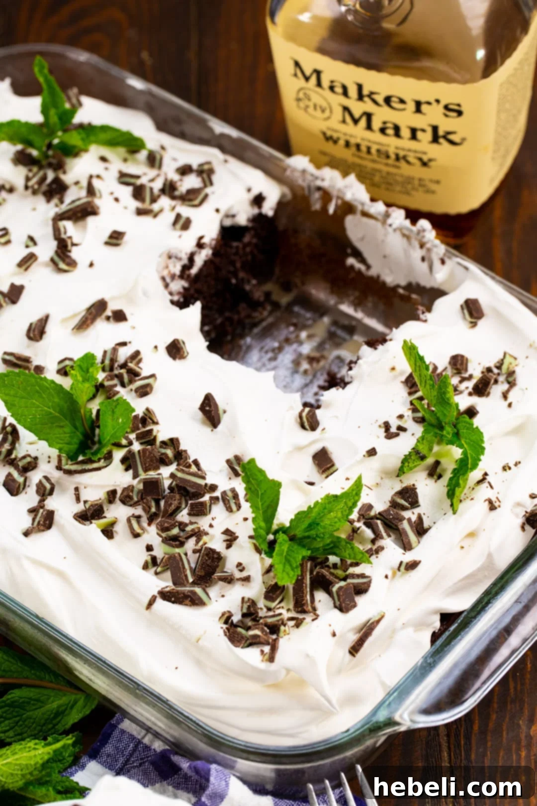 Bourbon Mint Infused Delight 3 A baked cake in a 9x13-inch pan with a piece already removed, showing the moist interior.