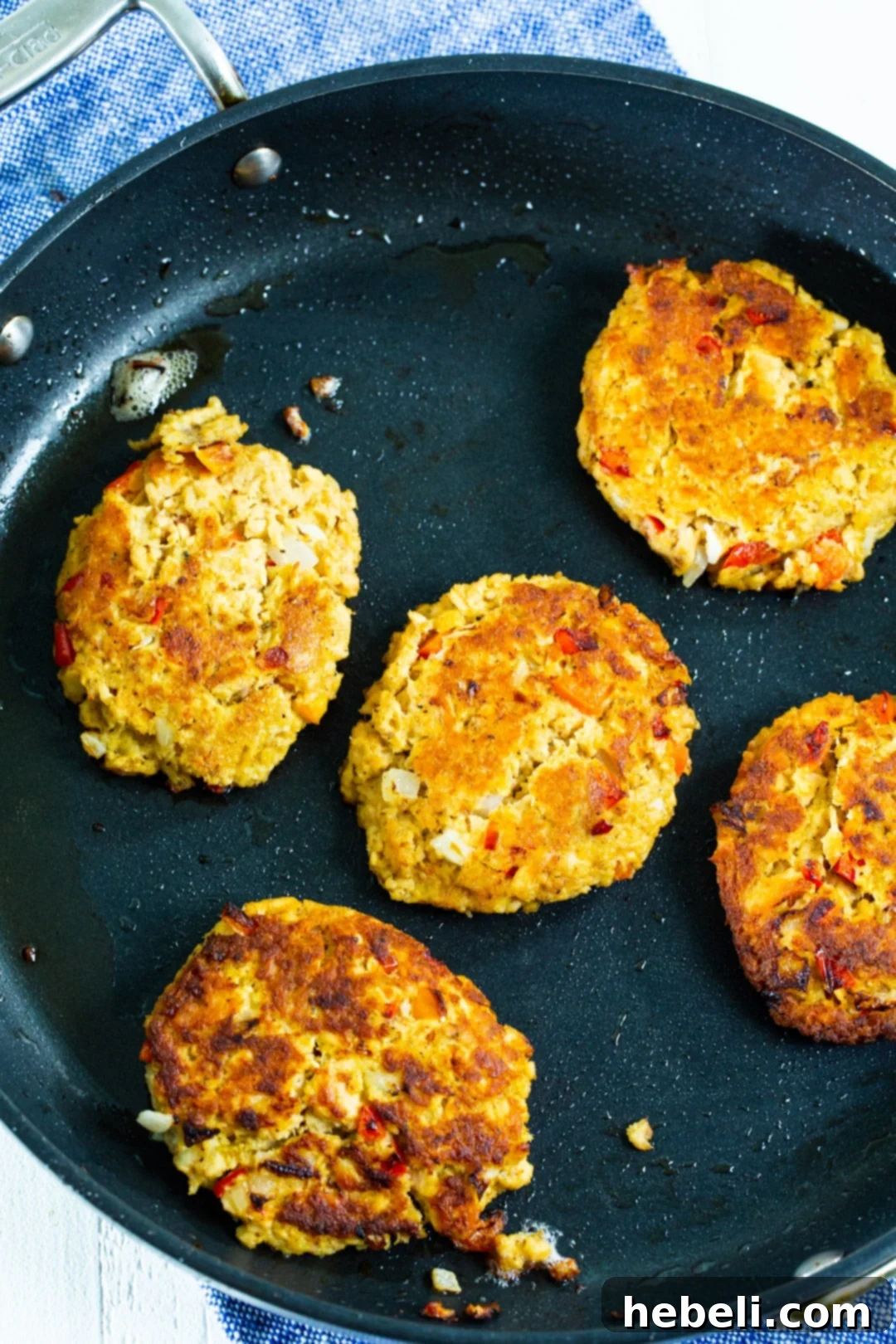 Zesty Bayou Salmon Fritters 3 Several salmon cakes sizzling in a nonstick skillet, achieving a perfect golden-brown crust.