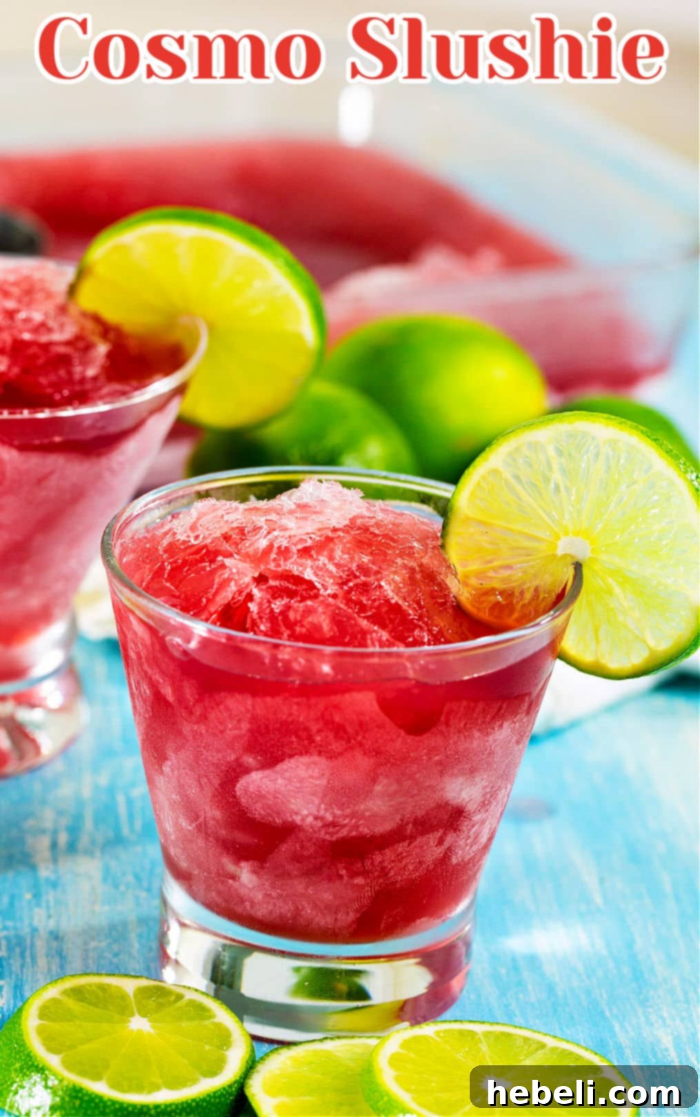 Single glass of Cosmo Slushie with a lime wedge garnish.