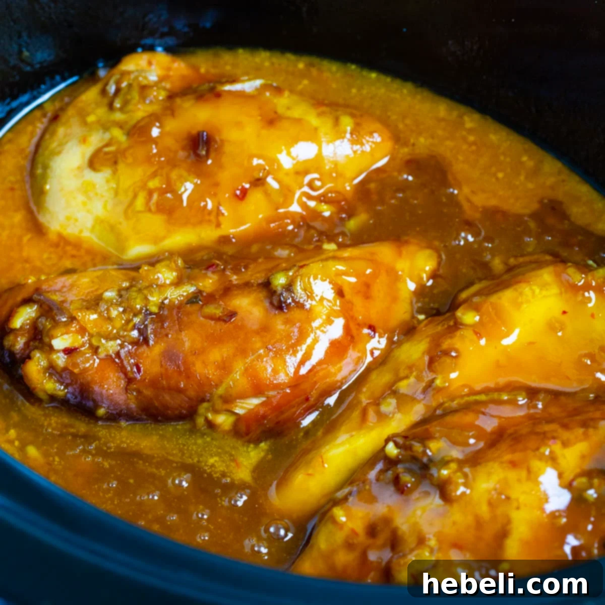 Slow Cooker Orange Chicken in a black crockpot.
