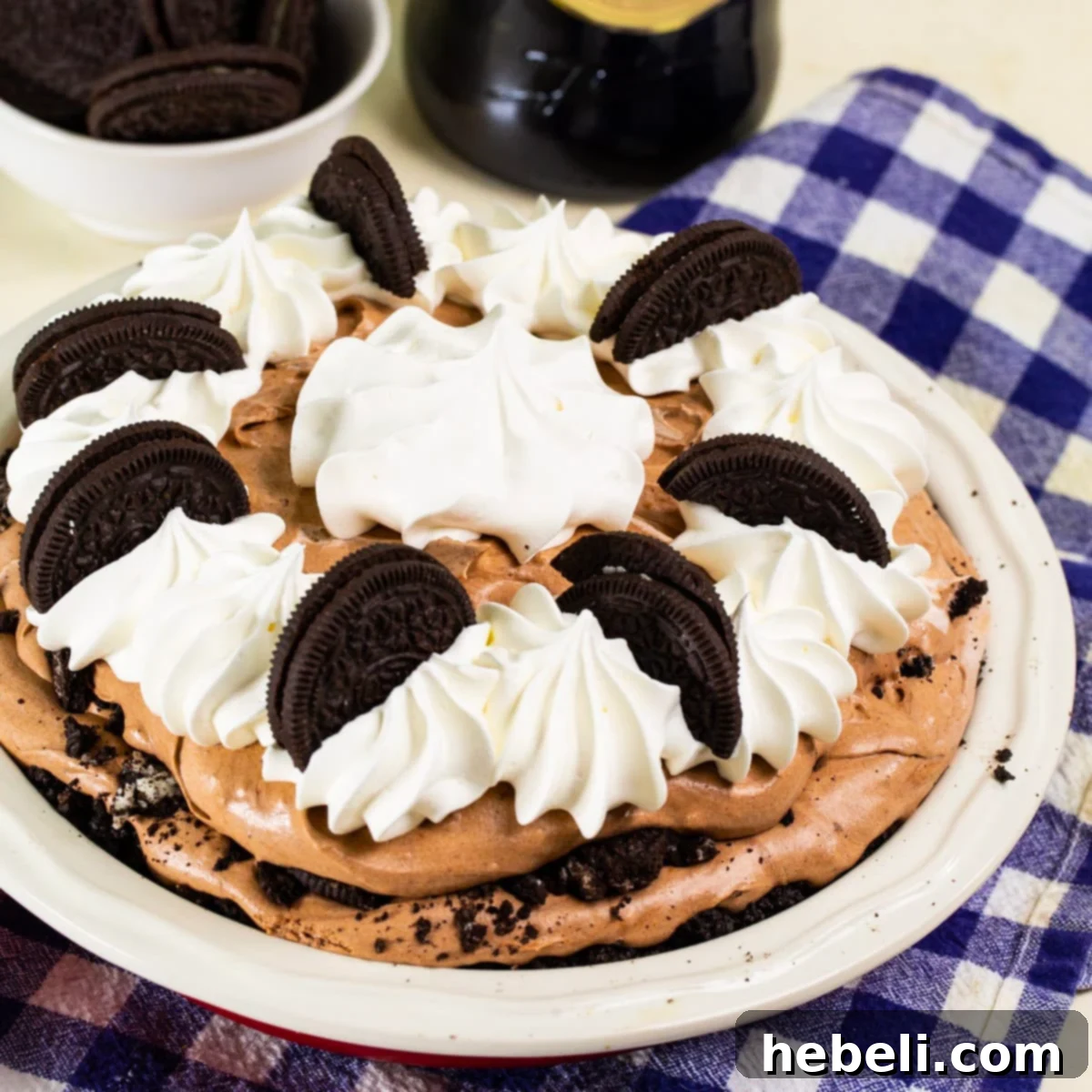 Whole Baileys Chocolate Cream Pie topped with whipped cream and oreo cookies.